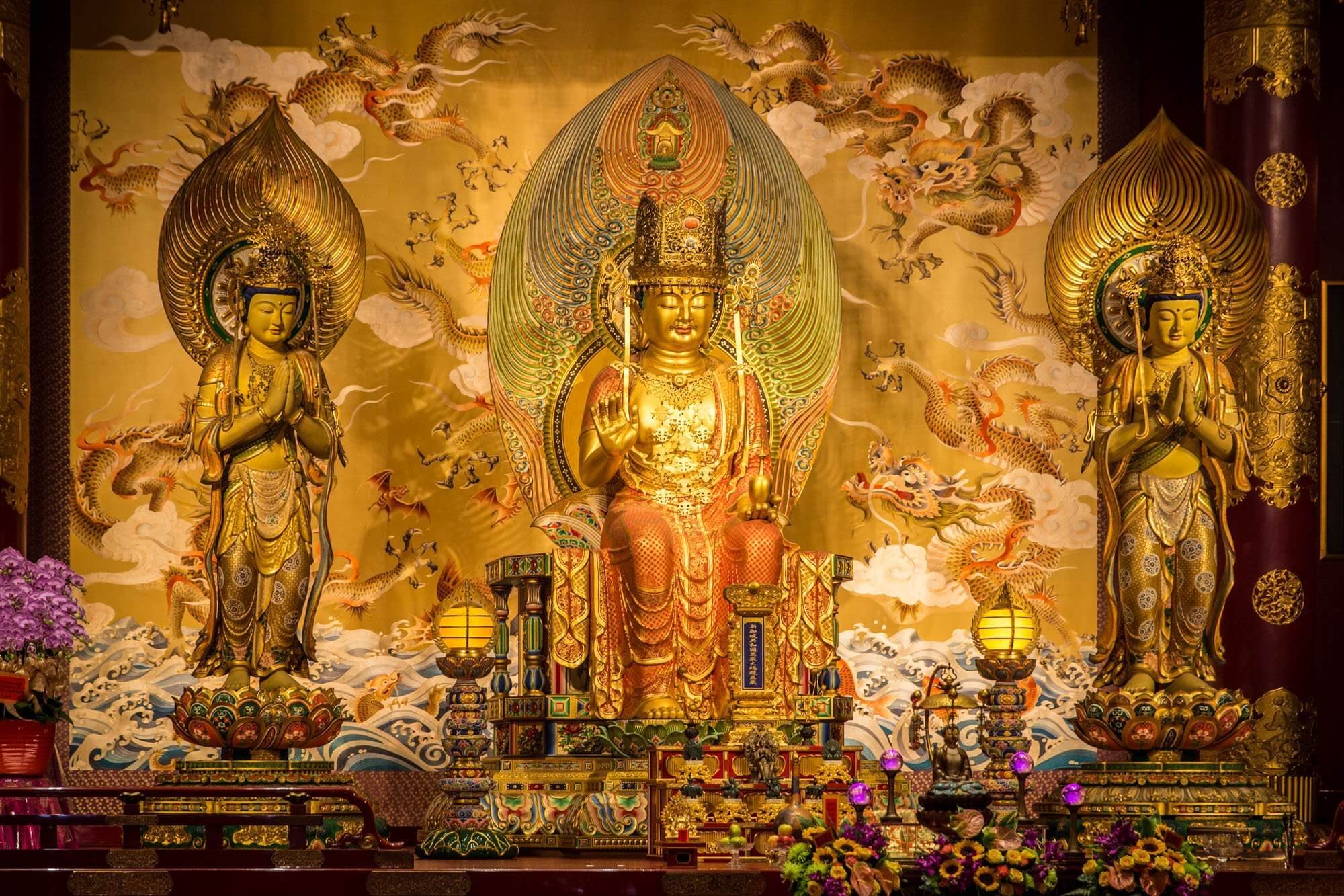 Buddha Maitreya flanked by two Bodhisattvas inside the Buddha Tooth Relic Temple in Singapore
