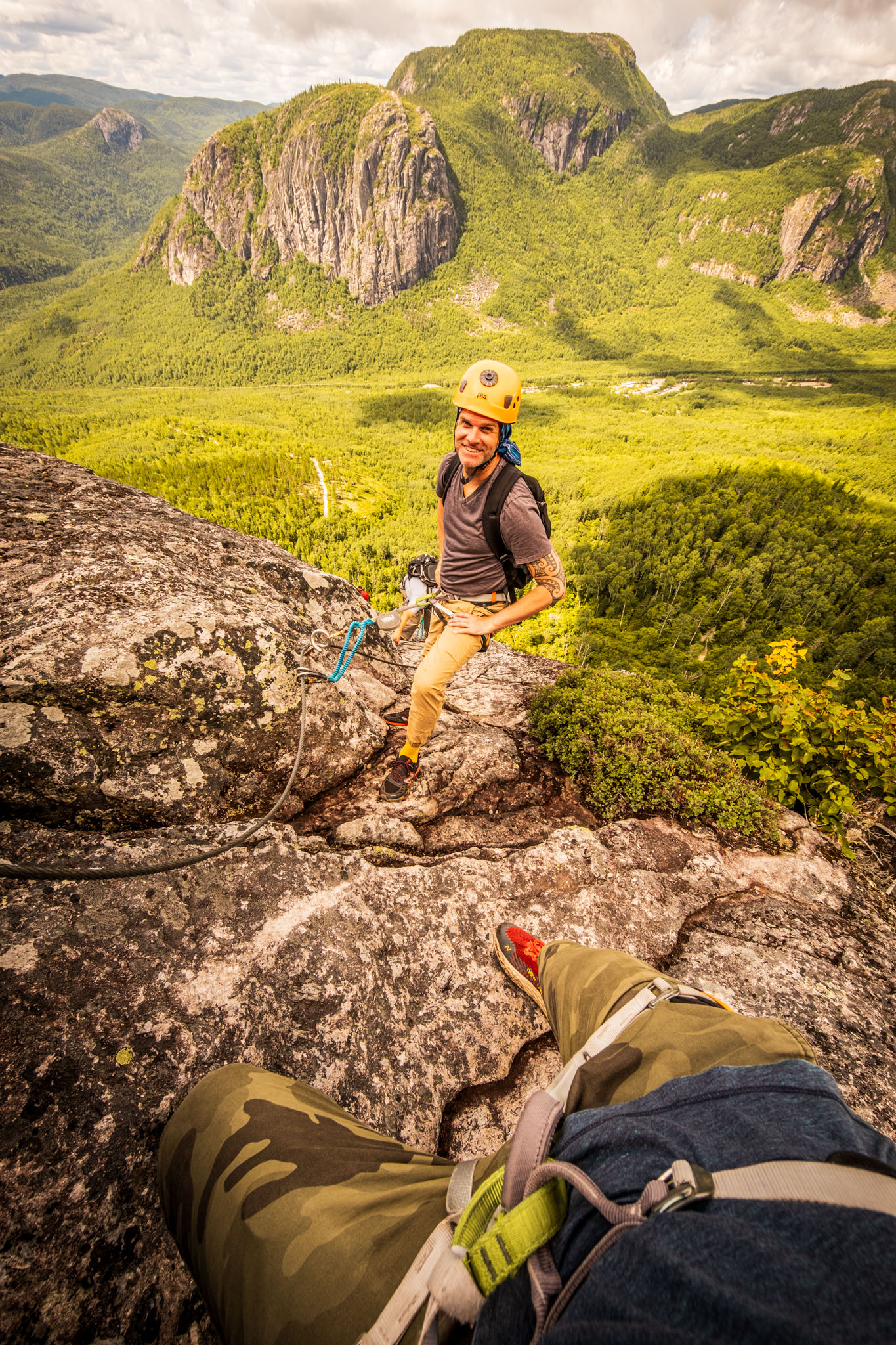 Via ferrata climbers posing for a photo in front of mountains at Parc national des Grands-Jardins