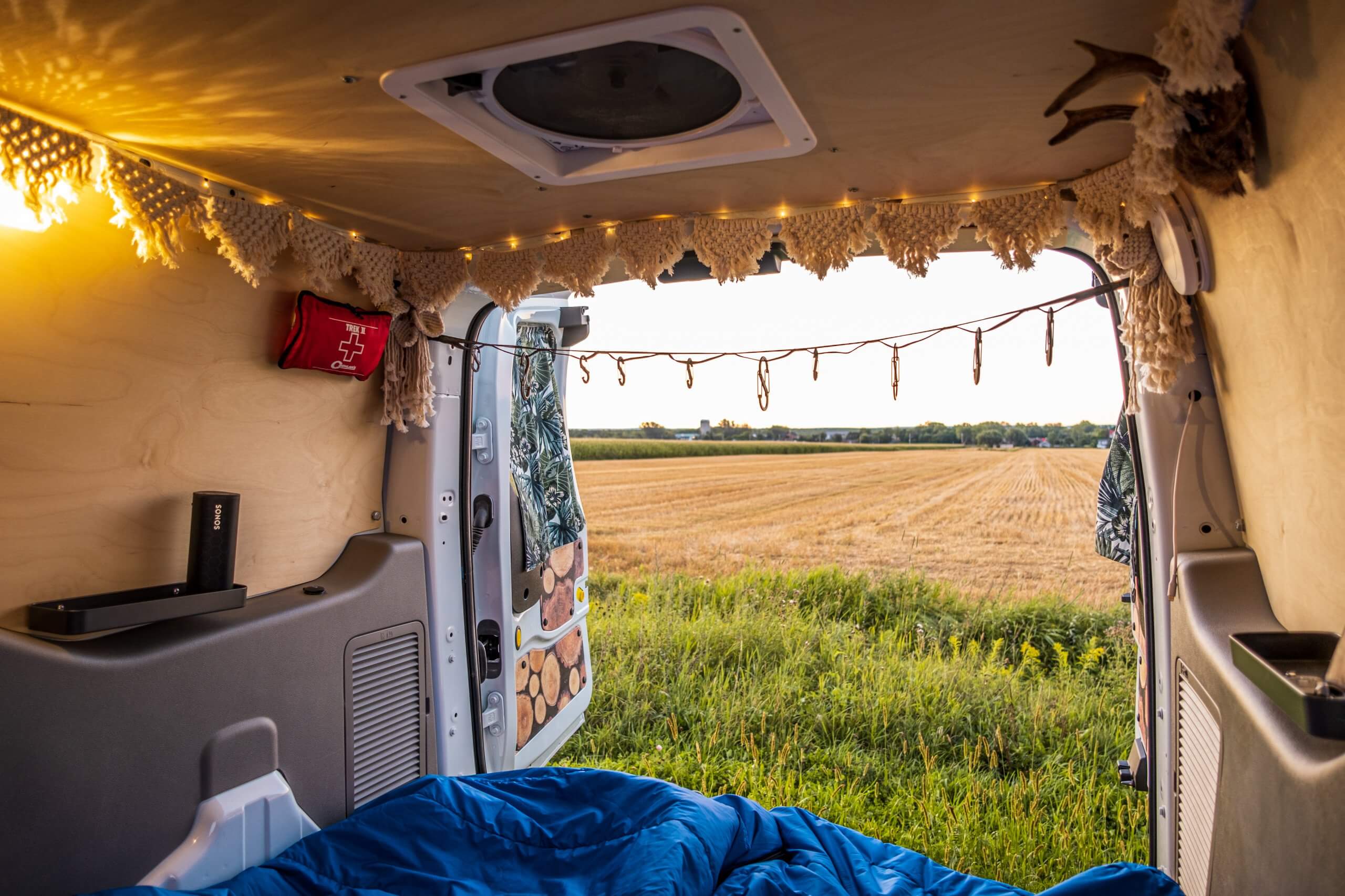 View through rear doors of a Ford Transit Connect camper van conversion