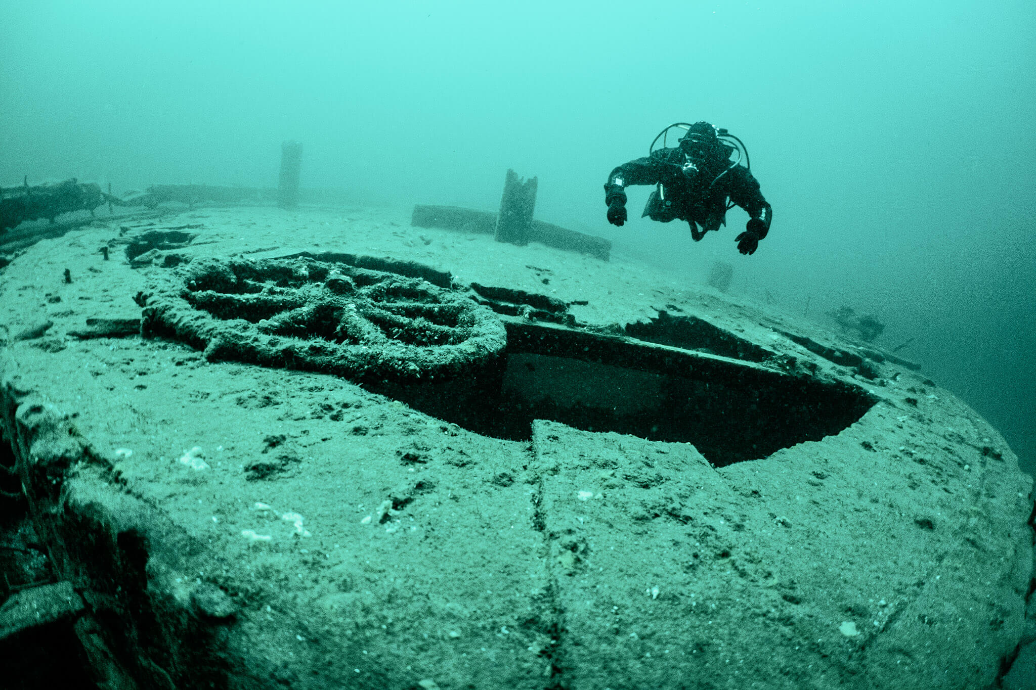 Scuba diver examines the wheel of the Kinghorn shipwreck in Rockport, Ontario