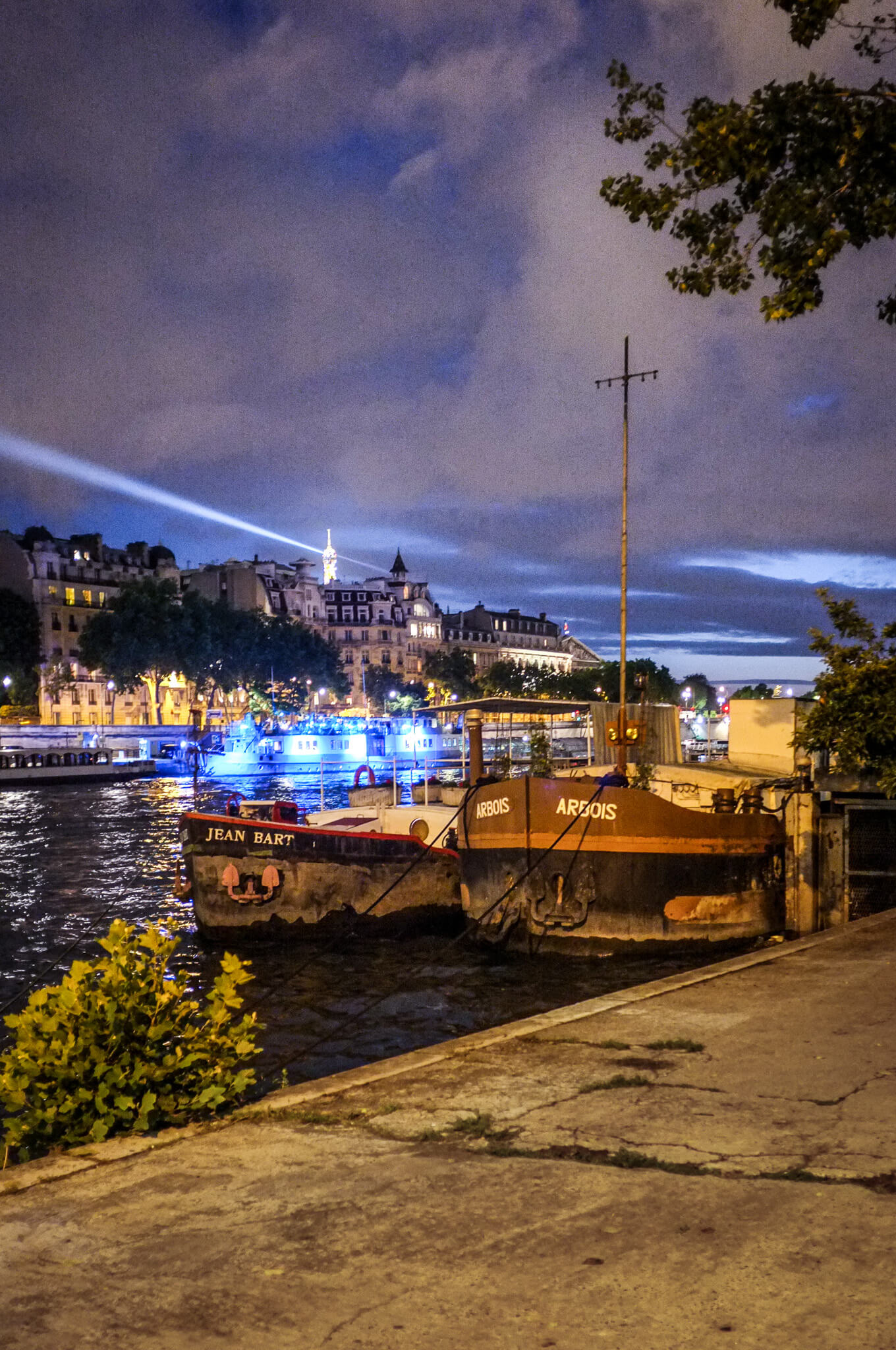 Seeing the spotlight from the Eiffel Tower at night at our houseboat on the Seine River in Paris