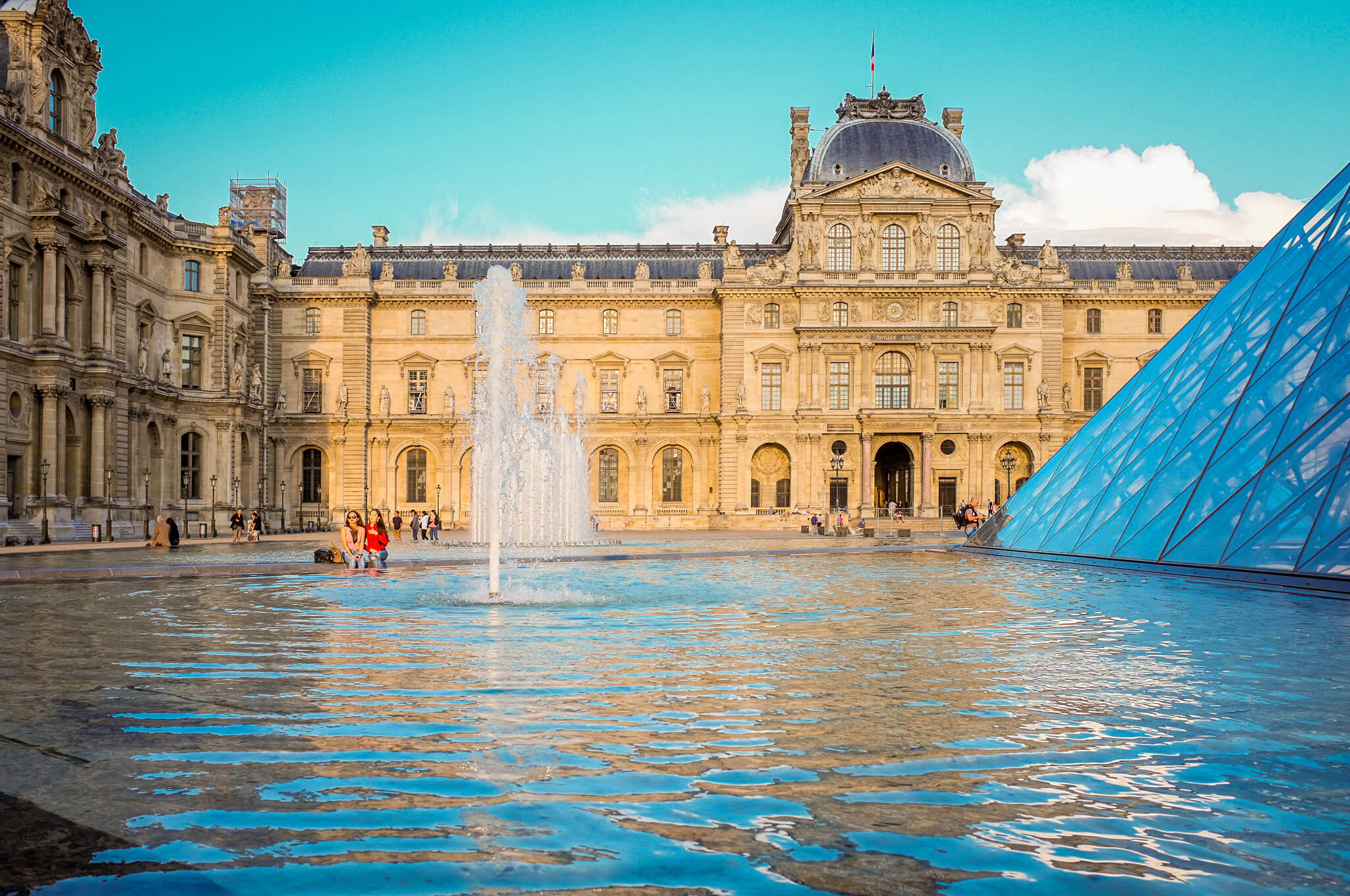 The exterior of the Louvre with the pyramid fountain in the foreground