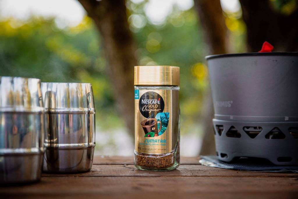 A jar of Nescafé Gold Origins Sumatra instant coffee on a picnic table