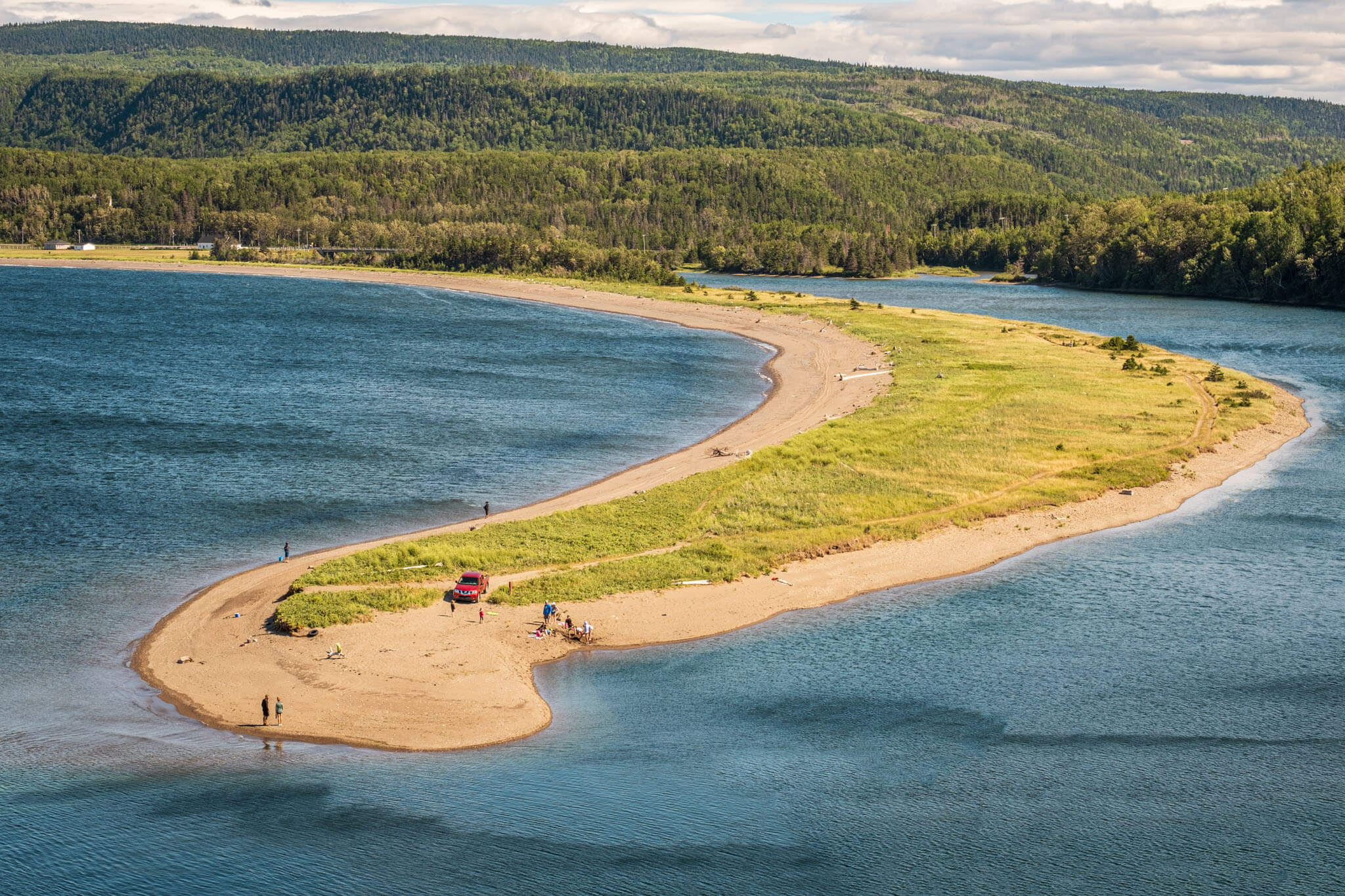 Sand spit with fishers and beachgoers in Sainte-Madeleine-de-la-Rivière-Madeleine