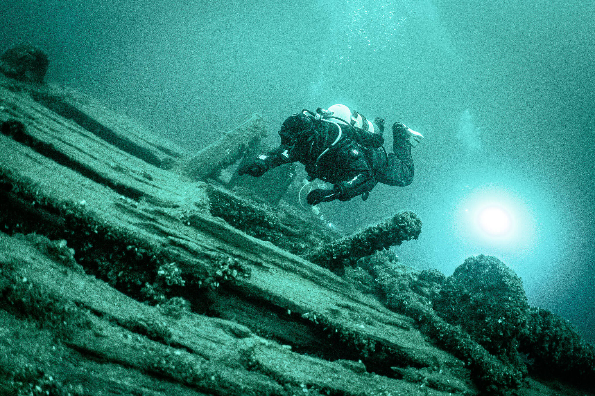 Underwater photo of a scuba diver exploring the Ash Island Barge in the St. Lawrence River