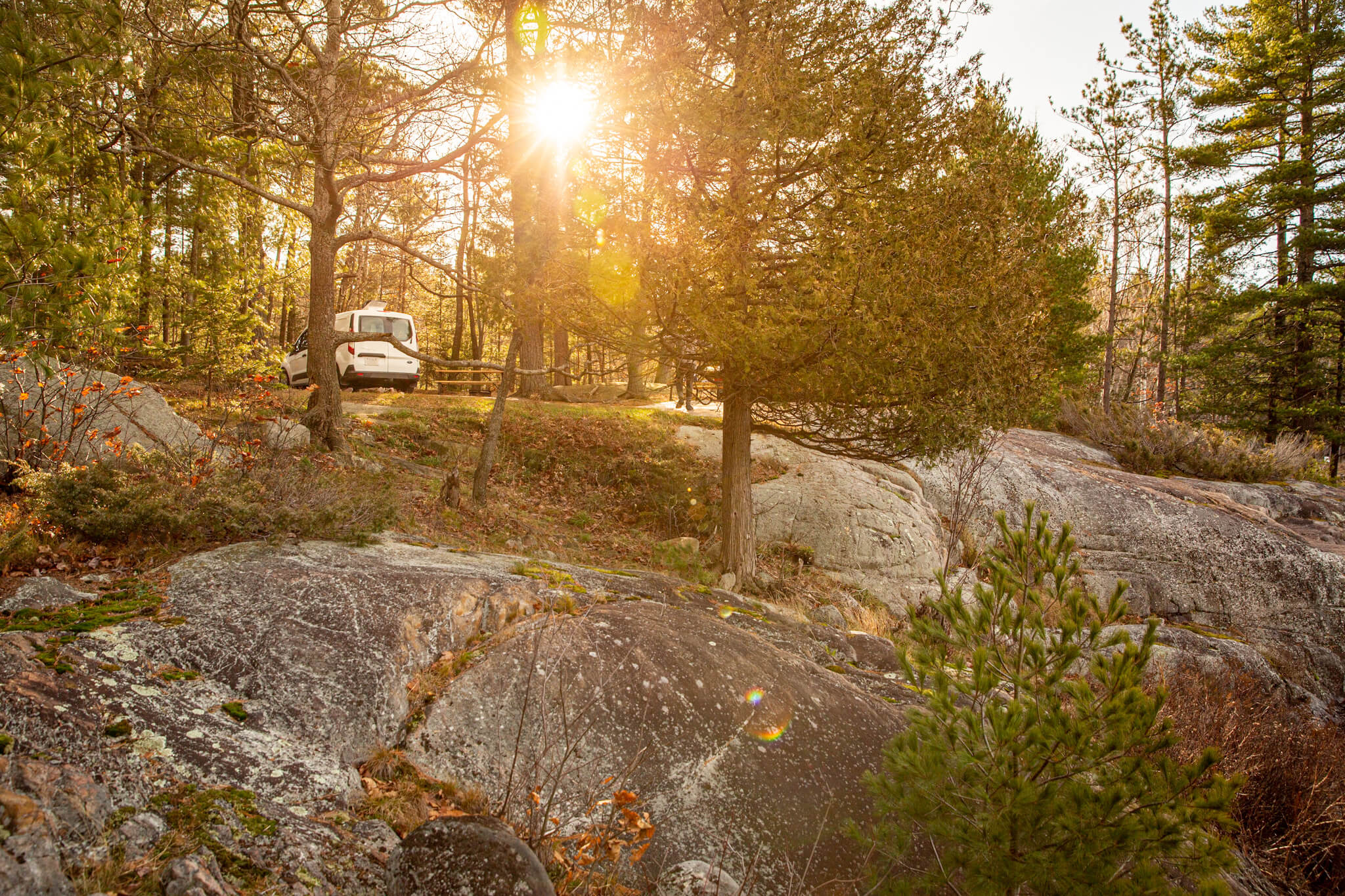 Converted Transit Connect camper van on a granite outcropping at Killarney Provincial Park