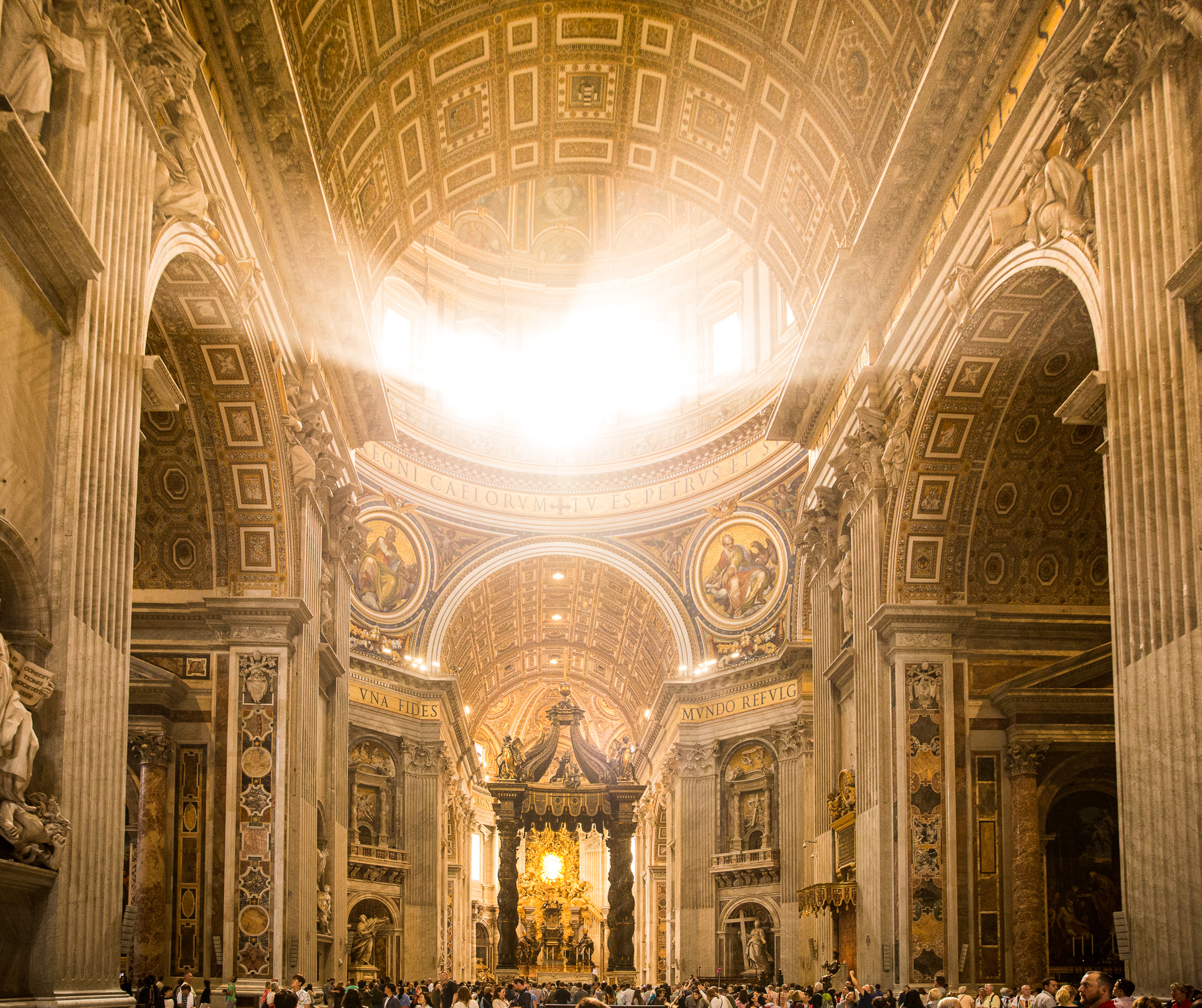 Rays of light shining through the dome of Saint Peter's Basilica