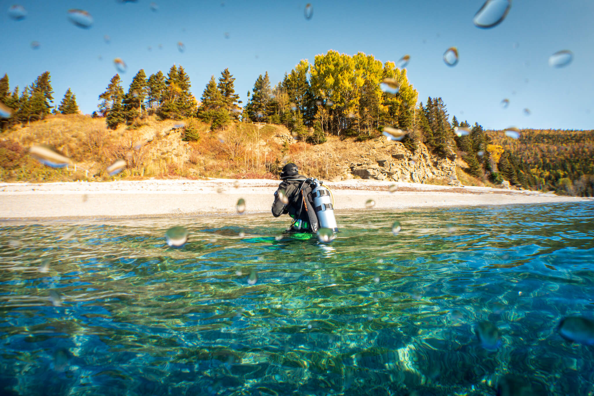 Scuba diver emerging from the sea at Forillon National Park, Gaspé, Quebec
