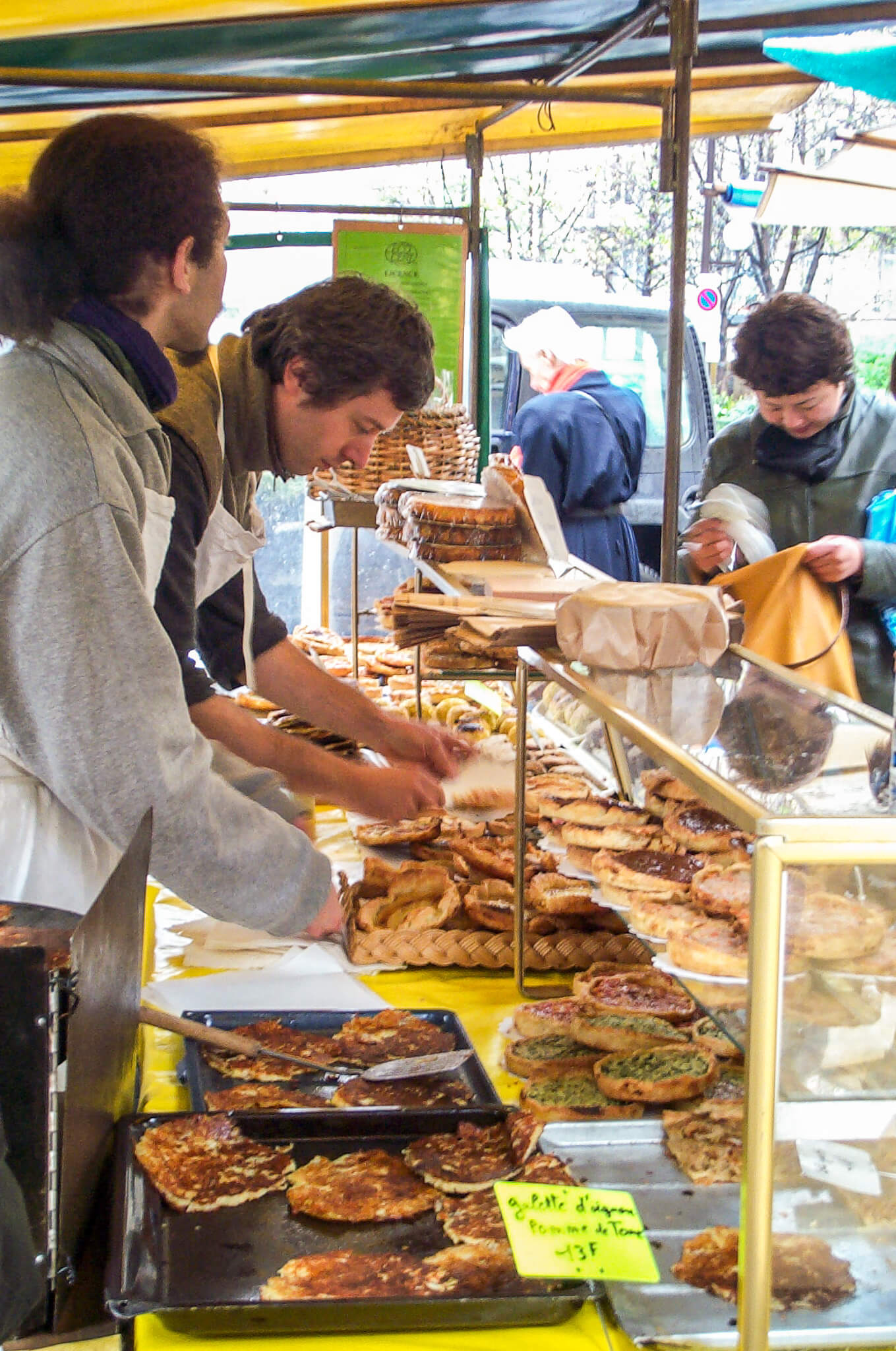 Baked goods at a bustling street market in Paris