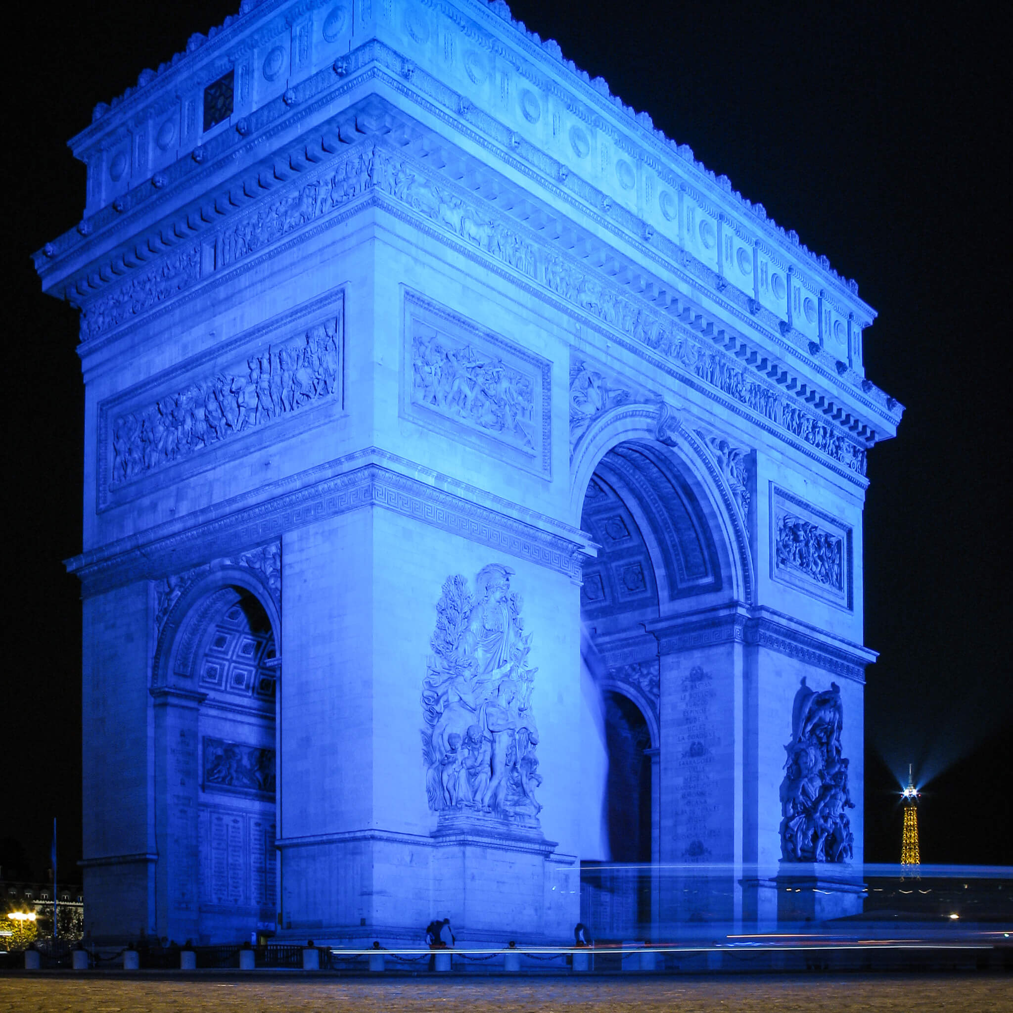 The Arc de Triomphe at night, lit up in blue